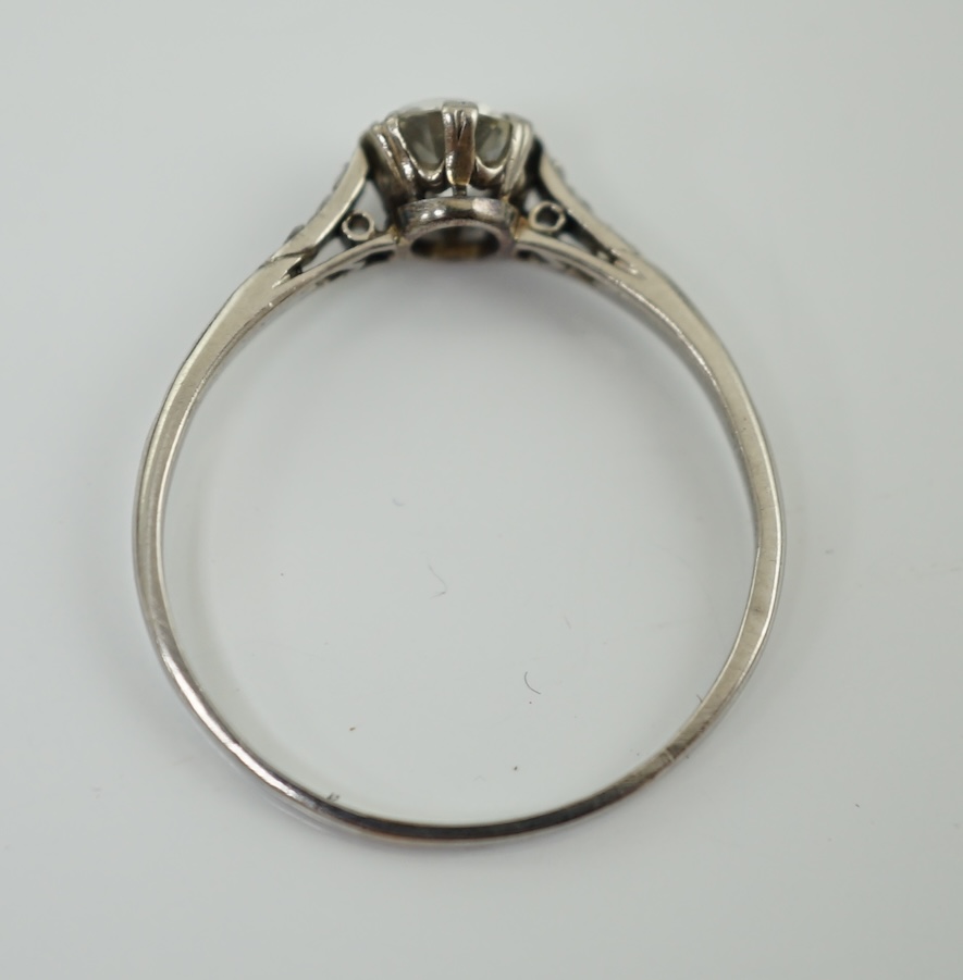 A platinum? and single stone diamond set ring, with six stone diamond chip set shoulders